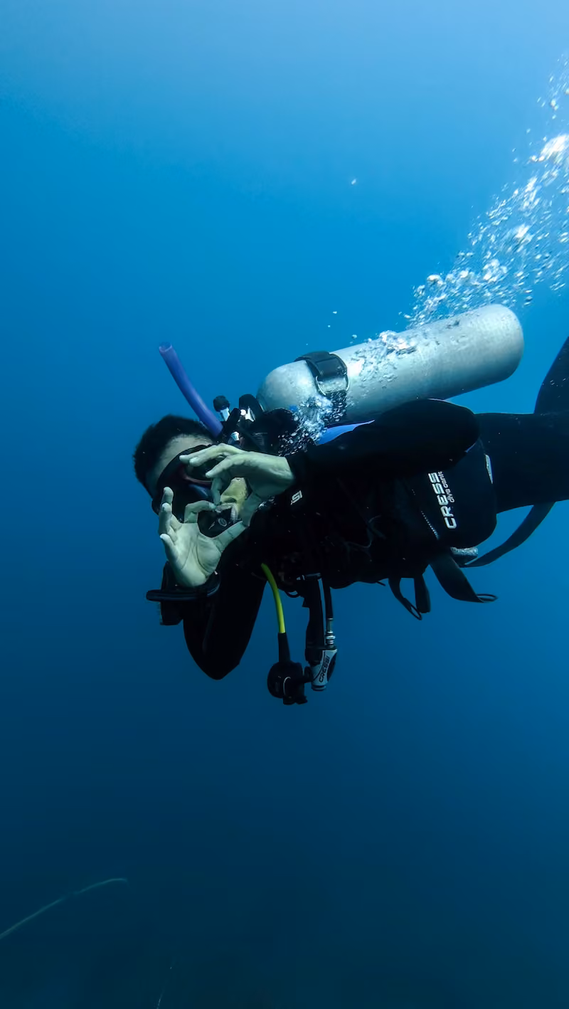 Diver making a hand heart underwater