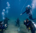 Students doing exercises underwater with their instructors